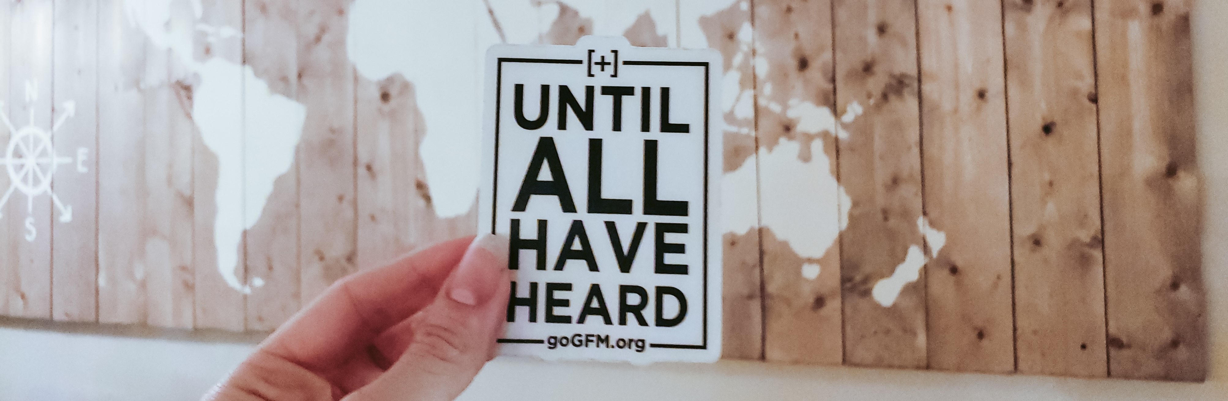 wall map with a card in front of it "Until All Have Heard"